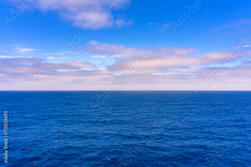 Blue ocean sea water with a clouds and sky in the horizon