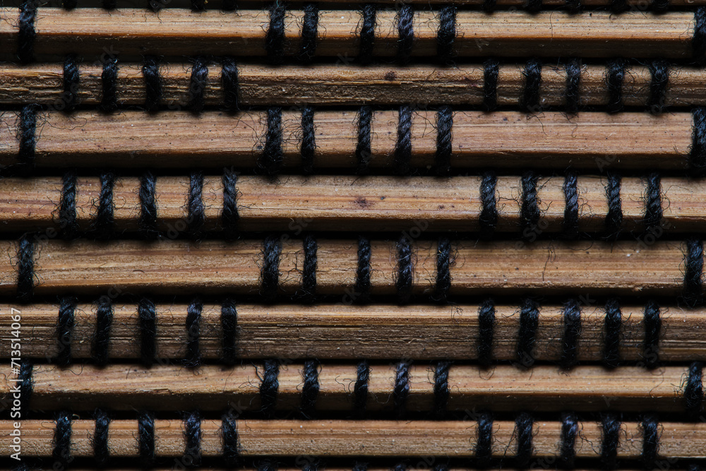 Brown background made of braided wooden slats.