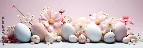 Easter concept with colorful eggs of delicate colors and flowers in a minimalist style with copy space. Banner on a pink background.
