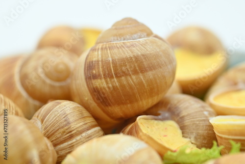 Delicatessen food - Bourgogne Escargot Snails with garlic butter in a pan., white background. Top view