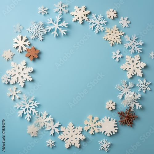 winter composition with white and blue background. Circle of colorful blue and white winter snowflakes on a beige background. Flat lay  top view  copy space