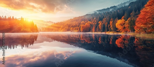 view of the calm lake with the reflection of the colorful sunset