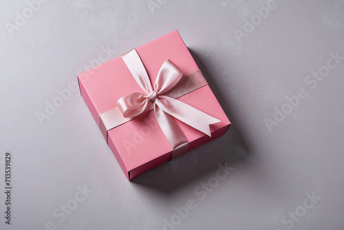 pink gift box on the grey paper background 