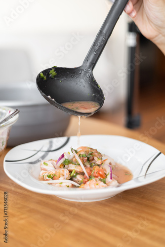 appetizing shrimp ceviche with onions, tomato and spices as ingredients, studio photo for restaurant menu, healthy soup with seafood, dish details