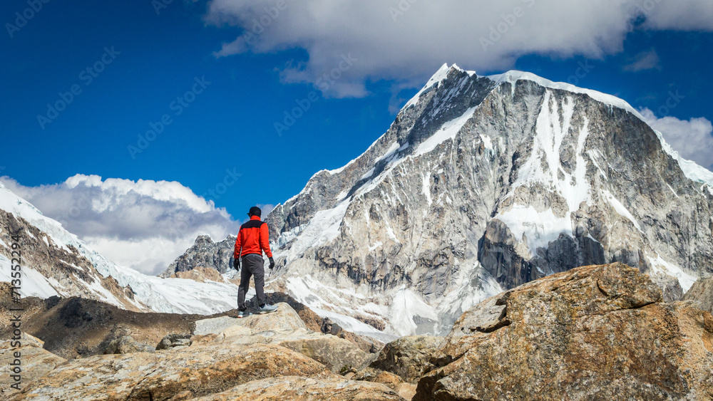 man standing in front of mountain in peru man standing in front of mountain in peru