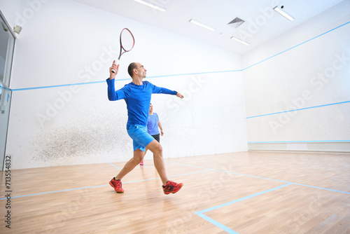 Active men enjoying playing squash displaying agility and love for competition