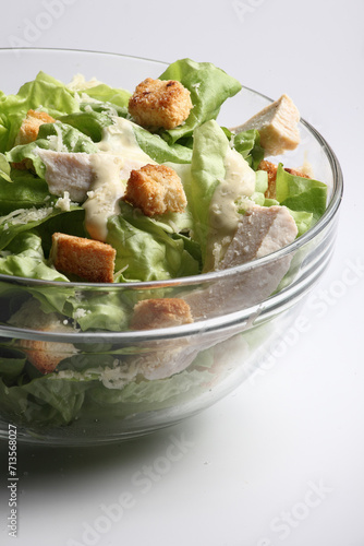 Close up of a bowl of Cesar Salad isolated inwhite background photo