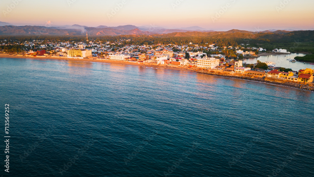 Barra de Navidad Aerial of Jalisco Mexico resort beach town with pacific coastline ocean view at sunset and lake lagoon