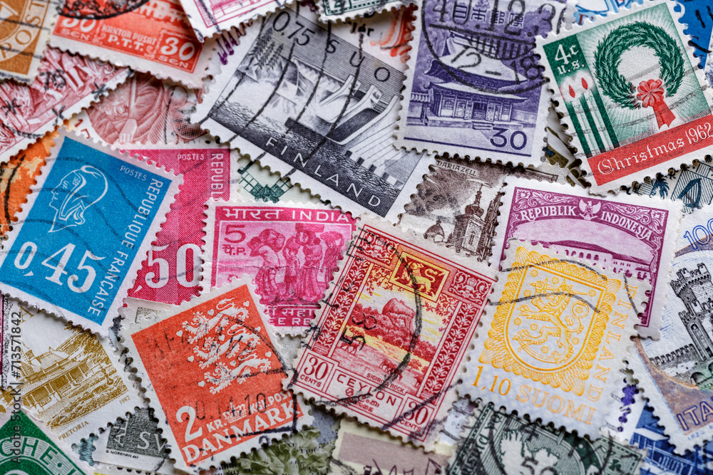 Postage stamps.A collection of world stamps in a pile.Postage stamps from different countries and times