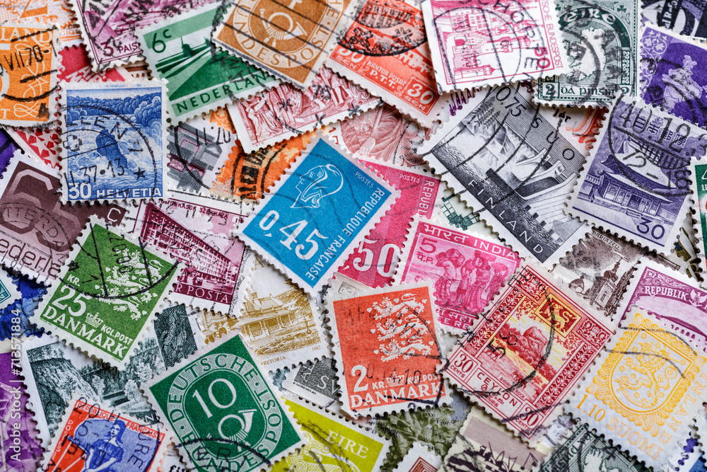 Postage stamps.A collection of world stamps in a pile.Postage stamps from different countries and times