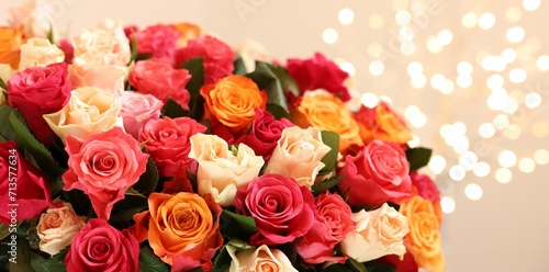Beautiful bouquet of colorful roses on beige background, closeup © New Africa
