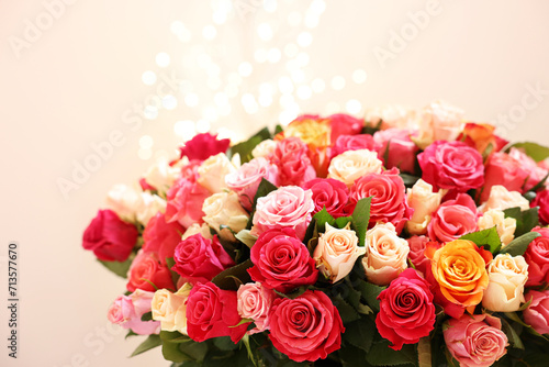 Beautiful bouquet of colorful roses on beige background © New Africa