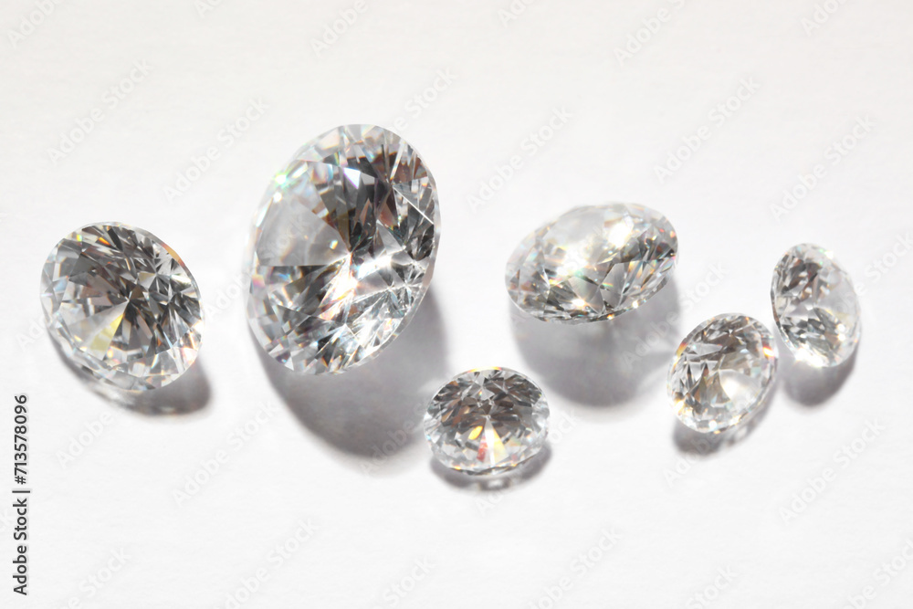 Many beautiful shiny diamonds on white background Many beautiful shiny diamonds on white background