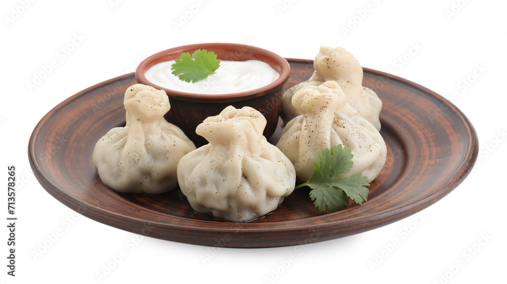 Tasty khinkali (dumplings) with sauce and spices isolated on white. Georgian cuisine