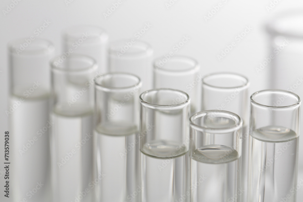 Laboratory analysis. Many glass test tubes on blurred background, closeup Laboratory analysis. Many glass test tubes on blurred background, closeup