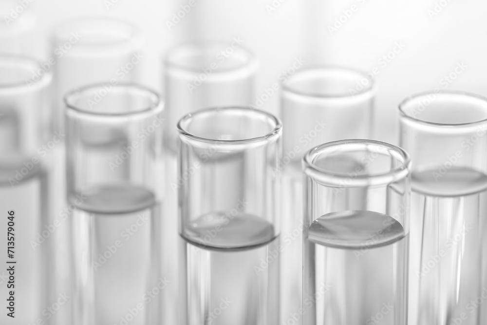 Laboratory analysis. Many glass test tubes on blurred background, closeup Laboratory analysis. Many glass test tubes on blurred background, closeup
