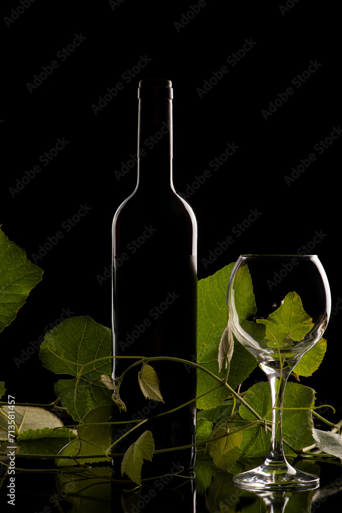 Wine and glass, a beautiful low key photo of a wine bottle and glass in silhouette, selective focus.