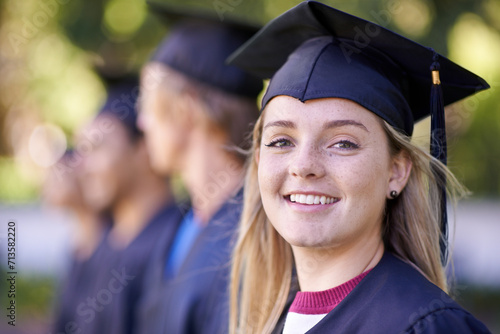 Happy woman, portrait and student in outdoor graduation for education, learning or qualification. Female person or graduate smile in group for higher certificate, diploma or degree at campus ceremony photo
