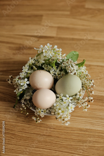 Chic Blooms: Easter's Refined Still Life Stylish Easter Decor. Easter composition. Chiken eggs decorated with flowers on the table