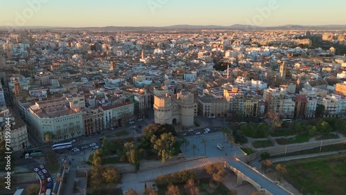 The Serranos Towers stand proud amidst Valencia's sprawling cityscape bathed in the warm glow of the golden hour. Slow Motion, Camera 4K RAW. 
