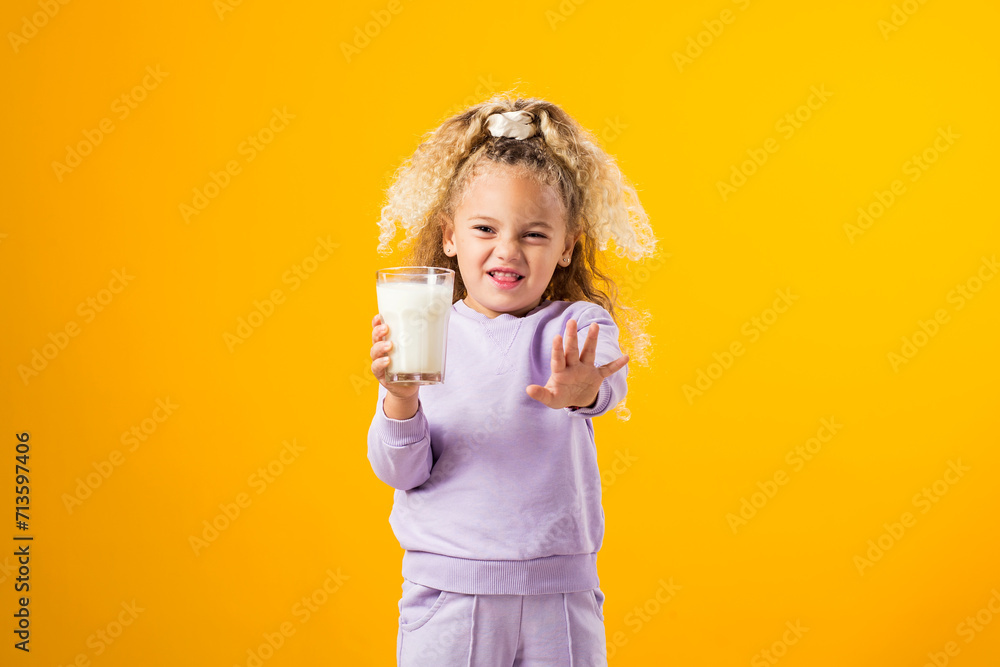 Young Girl Expressing Dislike with a Glass of Milk . Illustrating Lactose Intolerance and the Importance of Health Care