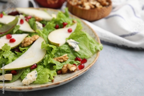 Delicious pear salad on grey textured table, closeup. Space for text