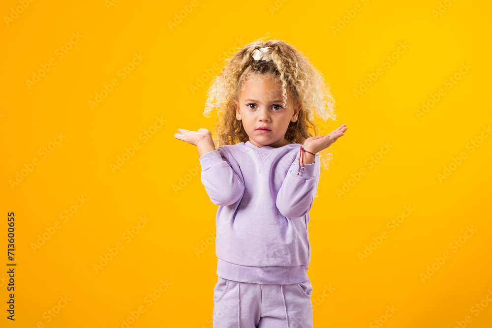 Surprised child girl spreading her arms to the sides. Surprised child girl spreading her arms to the sides.