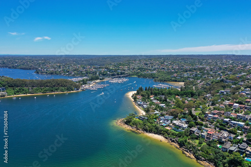 High angle aerial drone view of Spit Bridge, Clontarf Beach and Sandy Bay in the suburb of Clontarf, Sydney, New South Wales, Australia. Northern Beaches area of Sydney in the background.