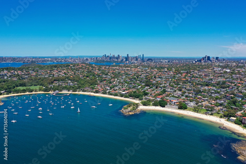 High angle aerial drone view of Balmoral Beach and Edwards Beach in the suburb of Mosman, Sydney, New South Wales, Australia. CBD, North Sydney in the background.