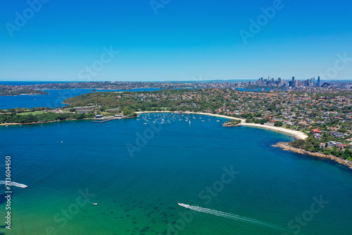 High angle aerial drone view of Balmoral Beach and Edwards Beach in the suburb of Mosman, Sydney, New South Wales, Australia. CBD and South Sydney in the background.
