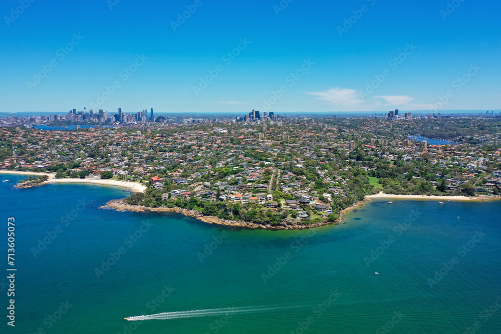 High angle aerial drone view of Edwards Beach and Chinamans Beach in the suburb of Mosman, Sydney, New South Wales, Australia. CBD, North Sydney and Chatswood in the background.