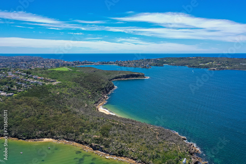 High angle aerial drone view of Grotto Point and Washaway Beach in the suburb of Clontarf, Sydney, New South Wales, Australia. Manly and North Head in the background. © PicMedia