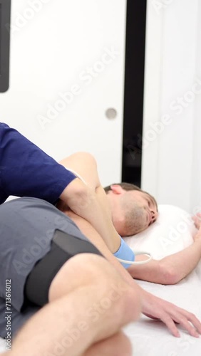 Video of a male patient lying while female cardiologist performing an echocardiogram