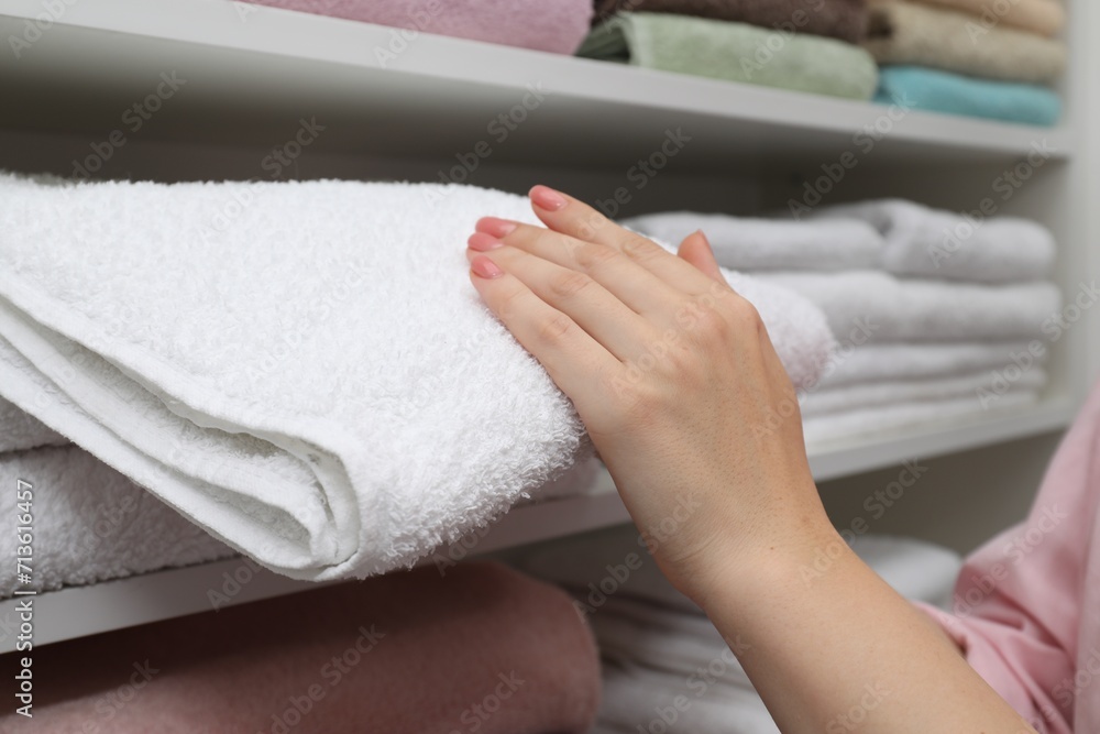 Customer choosing towel in linen shop, closeup Customer choosing towel in linen shop, closeup