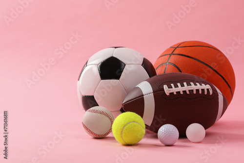 Many different sports balls on pink background  space for text