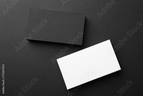Blank business cards on black background, flat lay. Mockup for design © New Africa