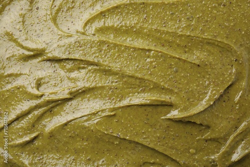 Tasty pistachio cream as background, top view