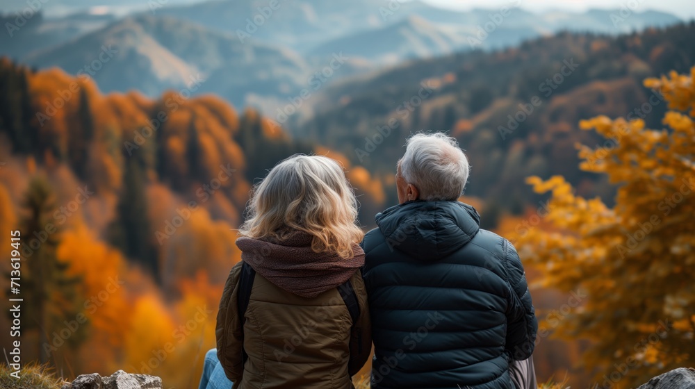 Elderly couple spends time together enjoying the natural sunset view outdoors.