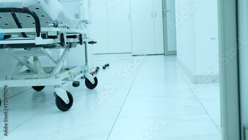 Healthcare, hospital and empty corridor with bed for medical care, health insurance and help in surgery. ER, emergency and lobby at clinic with stretcher 