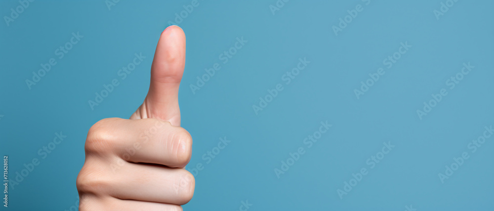 A thumbs-up from a woman hand, expressing approval or giving a like. A thumbs-up from a woman hand, expressing approval or giving a like.
