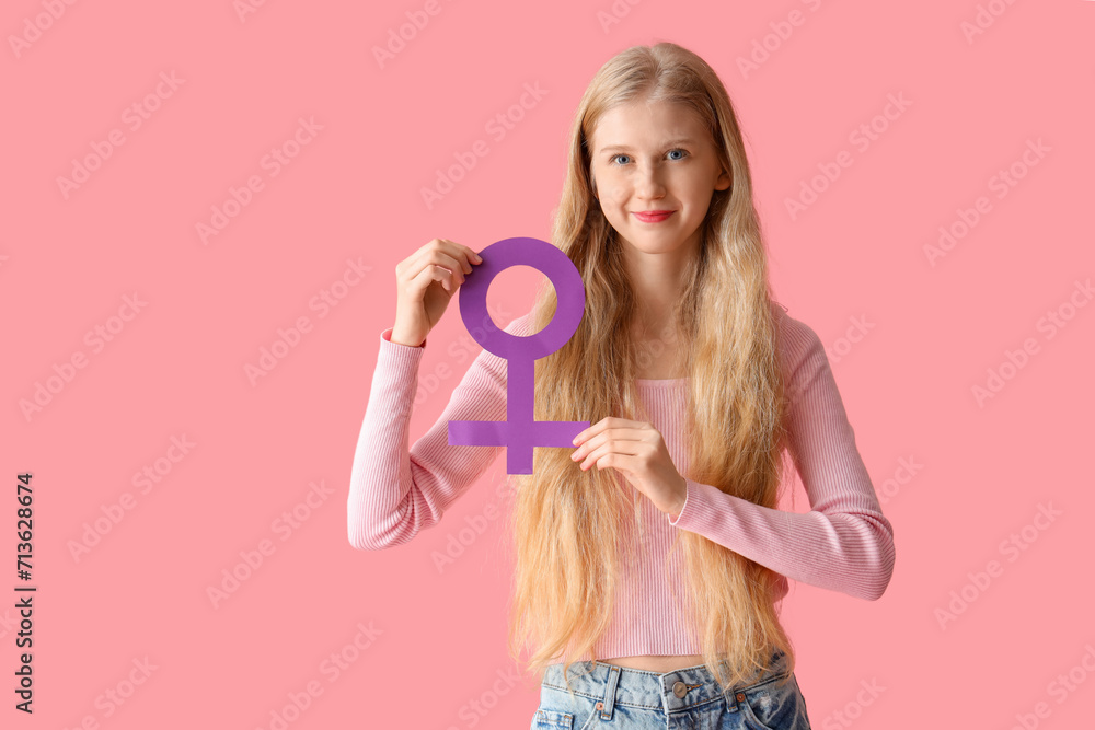 Young woman with gender symbol on pink background Young woman with gender symbol on pink background
