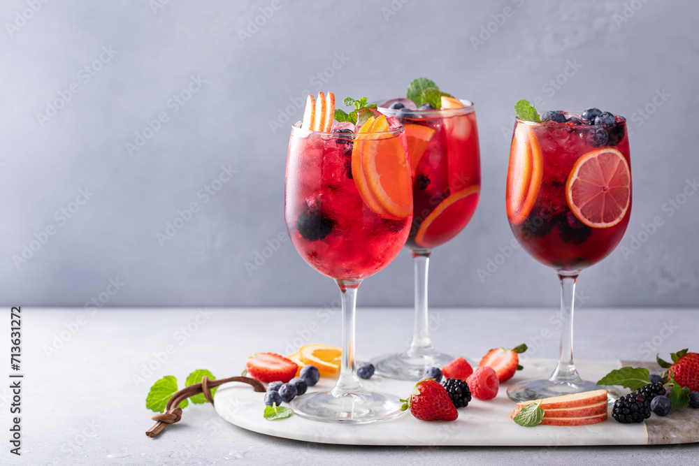 Berry sangria in wine glasses with oranges and a variety of berries