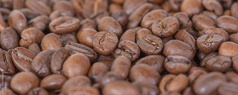 Roasted coffee beans as a background. Macro photo of coffee. Arabica. Banner background size. Roasted coffee beans as a background. Macro photo of coffee. Arabica. Banner background size.