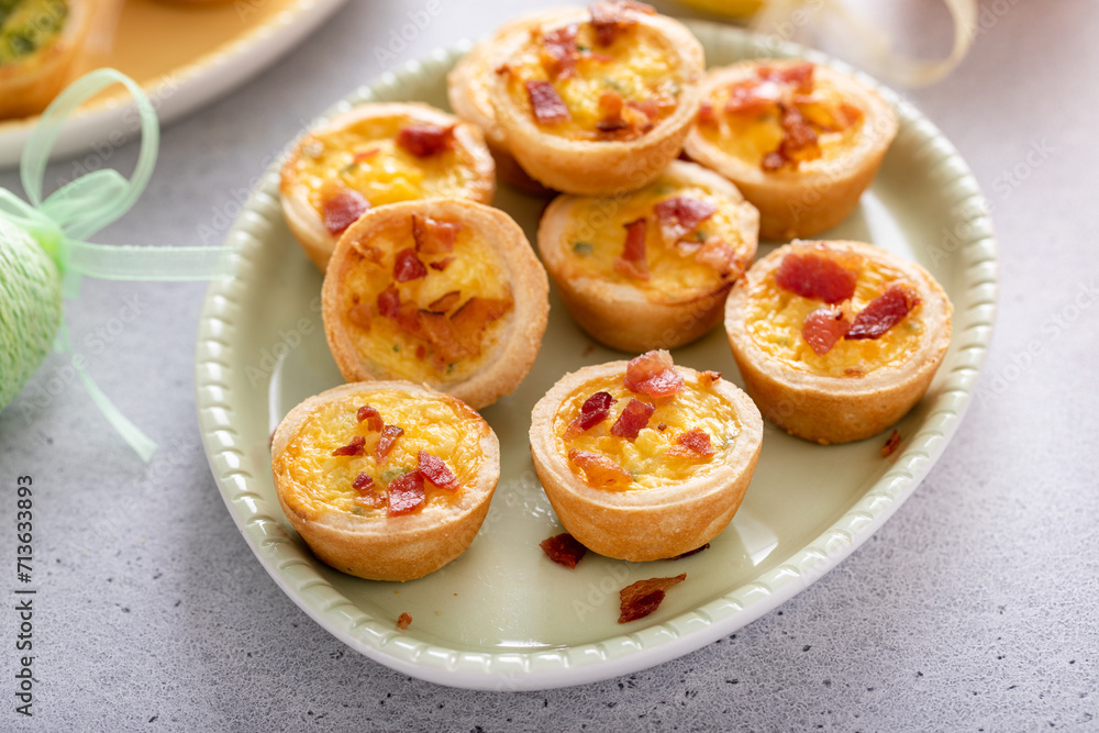 Mini quiches with ham and cheese topped with crispy bacon Mini quiches with ham and cheese topped with crispy bacon