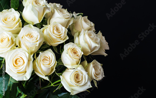 Bouquet of white roses on a black background with copy space