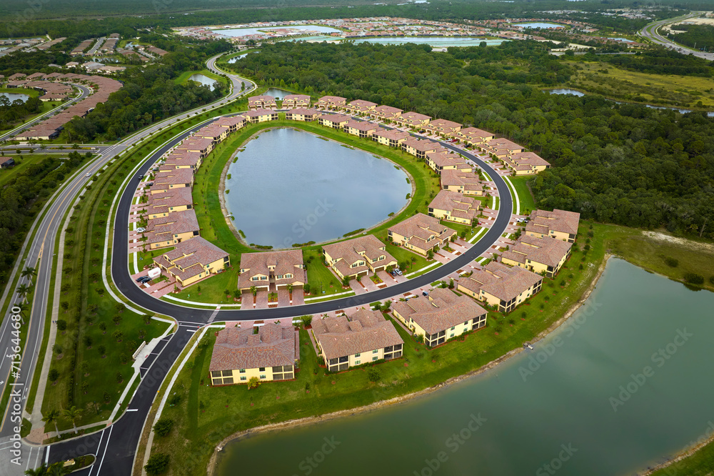 Aerial view of tightly located family houses with retention ponds to ...