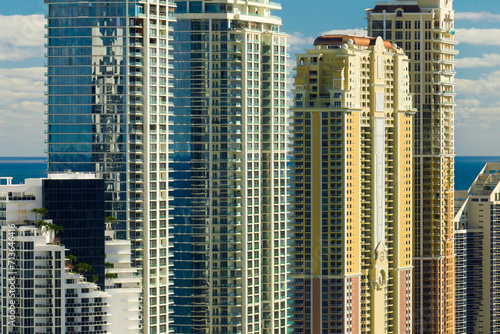 High angle view of Sunny Isles Beach city with expensive highrise hotels and condo buildings on Atlantic ocean shore. American tourism infrastructure in coastal southern Florida