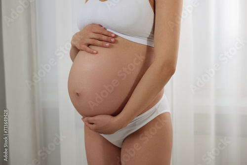 Pregnant woman in stylish comfortable underwear indoors, closeup