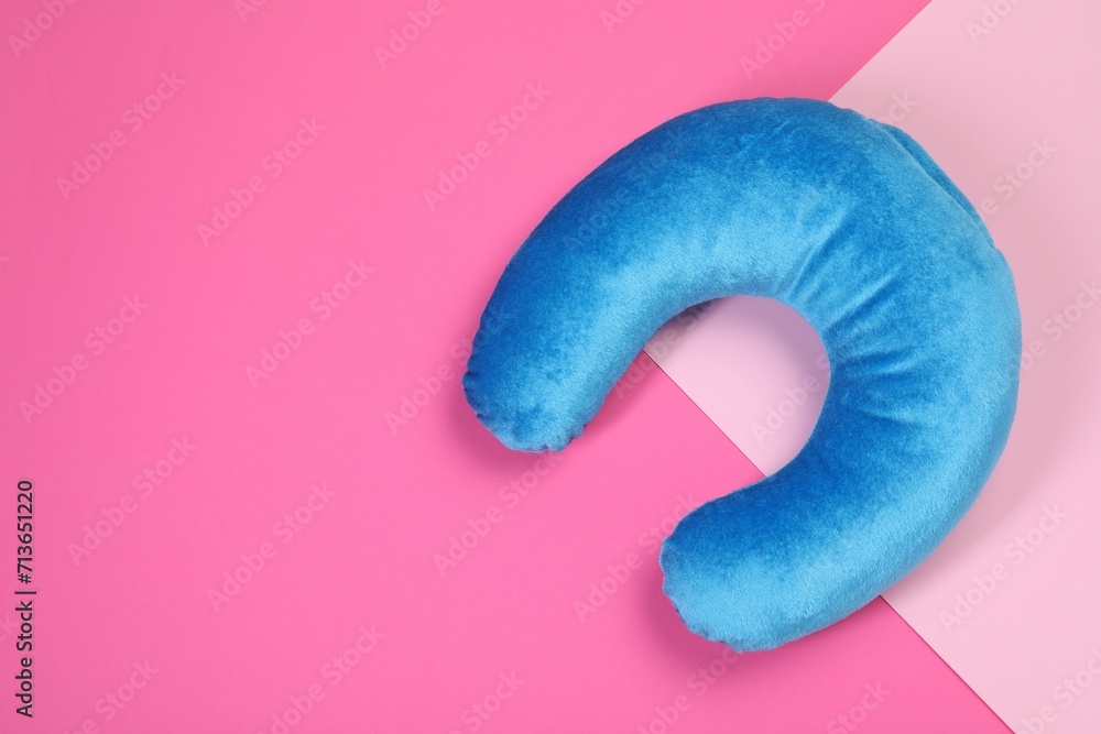 One blue travel pillow on color background, top view. Space for text One blue travel pillow on color background, top view. Space for text