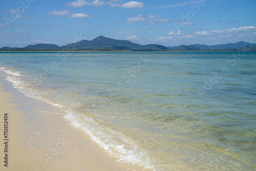 View of tropical island with white sand and turquoise crystal clear sea water.